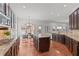 A kitchen features a large island, granite countertops, stainless steel appliances, and dark wood cabinetry at 1345 Hilltop Overlook Dr, Marietta, GA 30062