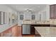 Open concept kitchen area with stainless steel appliances, hardwood floors and granite countertops at 1345 Hilltop Overlook Dr, Marietta, GA 30062