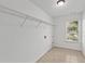 Laundry room with tile floors, a utility sink, and a window for natural light at 1345 Hilltop Overlook Dr, Marietta, GA 30062
