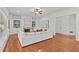 Bright, open-concept living room with hardwood floors, fireplace, built-ins and a comfortable white sectional sofa at 1345 Hilltop Overlook Dr, Marietta, GA 30062