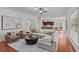 Spacious living room with plush seating, stylish rug, and views of the adjacent dining and kitchen areas at 1345 Hilltop Overlook Dr, Marietta, GA 30062