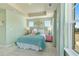 A bedroom with a plush bed, tray ceiling, colorful decor, and natural light from the windows at 520 Provence Gate Ln, Lawrenceville, GA 30044