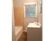 Bright bathroom featuring a tub with tile surround and a window above the sink at 732 Vinson Sw Pl, Atlanta, GA 30315