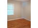 Comfortable bedroom featuring original hardwood floors, fresh paint, and a large window at 732 Vinson Sw Pl, Atlanta, GA 30315