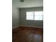 Bright bedroom featuring original hardwood floors, fresh paint, and a large window at 732 Vinson Sw Pl, Atlanta, GA 30315