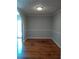 Cozy dining room featuring hardwood floors, wainscotting, updated paint, and an arched doorway at 732 Vinson Sw Pl, Atlanta, GA 30315