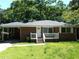 Charming single-story house with a brick and wood facade, cozy front porch, and a well-shaded lawn at 732 Vinson Sw Pl, Atlanta, GA 30315