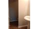 Updated powder room featuring a pedestal sink, modern flooring, and fresh paint at 732 Vinson Sw Pl, Atlanta, GA 30315