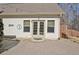 Cozy backyard patio with double doors leading into the home and decorative string lights at 209 Wynnward Way, Sharpsburg, GA 30277