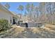 Expansive backyard with an outdoor dining area, stone fireplace, and a charming pool, perfect for outdoor entertaining at 209 Wynnward Way, Sharpsburg, GA 30277
