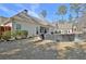 Inviting backyard featuring a cozy patio set, lush lawn, and the home's exterior at 209 Wynnward Way, Sharpsburg, GA 30277