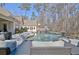 Lush backyard featuring a pool and fireplace that provide space for entertainment and relaxation at 209 Wynnward Way, Sharpsburg, GA 30277