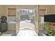 Indoor view of the outdoor living space complete with patio, pool, seating, and mature trees at 209 Wynnward Way, Sharpsburg, GA 30277