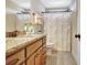 Bathroom features a granite vanity, a floral shower curtain, and a neutral color palette at 209 Wynnward Way, Sharpsburg, GA 30277