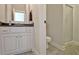 Modern half-bath featuring tiled floors, granite countertops, updated fixtures, and neutral paint at 209 Wynnward Way, Sharpsburg, GA 30277