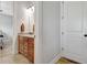 A charming bathroom with a wood cabinet vanity, granite counters, neutral tile floor and bright lighting at 209 Wynnward Way, Sharpsburg, GA 30277