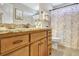 Bathroom featuring a granite vanity top, a floral shower curtain, and wood toned cabinets at 209 Wynnward Way, Sharpsburg, GA 30277