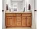 Double vanity bathroom with a granite countertop, dark wood cabinets, and elegant fixtures, creates functional beauty at 209 Wynnward Way, Sharpsburg, GA 30277