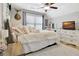 A sunlit bedroom with a plush white rug, decoratively pillowed bed, and a large window at 209 Wynnward Way, Sharpsburg, GA 30277