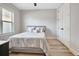 Minimalist bedroom design with gray walls, light hardwood floors, a large window, and double door closet at 209 Wynnward Way, Sharpsburg, GA 30277