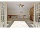 Open and airy bonus room with a ceiling fan, game table, and natural light through french doors at 209 Wynnward Way, Sharpsburg, GA 30277