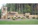 Attractive stone entrance to the 'Northwynn' community, set amidst mature trees at 209 Wynnward Way, Sharpsburg, GA 30277