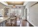 Elegant dining area features hardwood floors, tray ceiling and a view of the wooded backyard at 209 Wynnward Way, Sharpsburg, GA 30277