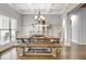 Bright, open dining room with modern chandelier and hardwood floors at 209 Wynnward Way, Sharpsburg, GA 30277