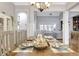 Charming dining room showcasing a beautifully set table, flowing seamlessly into the comfortable living space at 209 Wynnward Way, Sharpsburg, GA 30277