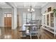 Warm dining area featuring a wooden table and chairs set, complemented by a built-in display cabinet at 209 Wynnward Way, Sharpsburg, GA 30277