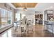 Bright dining area featuring hardwood floors, tray ceiling and a view of the kitchen at 209 Wynnward Way, Sharpsburg, GA 30277