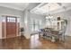 Inviting dining area with coffered ceilings, a modern chandelier, and stylish, rustic wooden furniture at 209 Wynnward Way, Sharpsburg, GA 30277