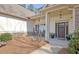 Charming front porch with rocking chairs and stone accents at 209 Wynnward Way, Sharpsburg, GA 30277