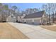 This home features a three-car garage and an additional detached garage at 209 Wynnward Way, Sharpsburg, GA 30277