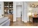 Hallway with hardwood floors and a view of a built-in bookcase at 209 Wynnward Way, Sharpsburg, GA 30277