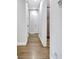 Bright hallway with hardwood floors offers a view into other rooms of the house, connecting spaces seamlessly at 209 Wynnward Way, Sharpsburg, GA 30277