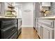 Bright kitchen featuring sleek black and gray cabinetry and hardwood floors at 209 Wynnward Way, Sharpsburg, GA 30277