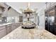 Spacious kitchen island featuring a unique, decorative centerpiece and granite countertops at 209 Wynnward Way, Sharpsburg, GA 30277