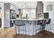 Spacious kitchen with large island, stylish pendant lighting, and stainless steel appliances at 209 Wynnward Way, Sharpsburg, GA 30277