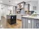 Beautiful kitchen features granite counters, gray cabinetry, and stainless steel appliances at 209 Wynnward Way, Sharpsburg, GA 30277