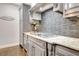 Stylish kitchen features granite countertops, custom cabinetry, and decorative backsplash at 209 Wynnward Way, Sharpsburg, GA 30277