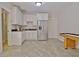 Charming kitchenette with stainless steel refrigerator, white cabinets and lots of countertop space at 209 Wynnward Way, Sharpsburg, GA 30277