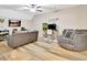 Bright living room featuring hardwood floors, neutral furniture, and a ceiling fan at 209 Wynnward Way, Sharpsburg, GA 30277