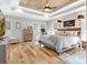 Spacious main bedroom with hardwood floors, ceiling fan, and tray ceiling at 209 Wynnward Way, Sharpsburg, GA 30277
