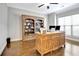 Stylish office with wooden desk, built-in bookshelf, and hardwood flooring; perfect for a productive workspace at 209 Wynnward Way, Sharpsburg, GA 30277
