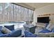 Relaxing outdoor space with comfortable seating, a TV, and a view of the pool and wooded backyard at 209 Wynnward Way, Sharpsburg, GA 30277
