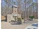 Inviting outdoor stone fireplace with seating area at 209 Wynnward Way, Sharpsburg, GA 30277