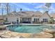 Backyard view with a large in-ground pool and comfortable seating area and the home's exterior at 209 Wynnward Way, Sharpsburg, GA 30277