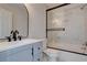 Updated bathroom with modern vanity, black accents, and a glass-enclosed tub/shower at 3680 Larkspur Ter, Decatur, GA 30032