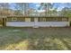 A charming single-story home with a partially-painted brick foundation at 3680 Larkspur Ter, Decatur, GA 30032